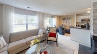 Located at 7400 Acorn Ct in North Royalton, Ohio, this single-floor residence offers a well-organized and thoughtfully designed layout. The living area is a welcoming focal point, featuring large windows dressed with sheer curtains that invite an abundance of natural light and offer views of the surrounding greenery. A textured ceiling adds architectural character, while plush carpeting and a neutral color palette create a warm, comfortable atmosphere. The space flows seamlessly into a dedicated dining area, making it well-suited for both relaxing and entertaining.

The galley-style kitchen is efficiently laid out, featuring white cabinetry, dark countertops, wood-look flooring, a double stainless steel sink, and black appliances including a refrigerator and range. A dedicated laundry area with a full-size washer and dryer adds everyday convenience.

The residence includes multiple bedrooms, each carpeted and filled with natural light from generously sized windows. The primary bedroom provides ample space and a relaxed, serene ambiance. Two full bathrooms serve the home, each equipped with a tub-shower combination, a single vanity with white cabinetry, and wood-look flooring, offering clean and functional design throughout.