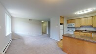 Located at 300 East Marshall Street in West Chester, PA, this single-floor residence offers a practical and well-organized layout with a clean, neutral aesthetic throughout. The open-concept living and dining area is finished with plush wall-to-wall carpeting and connects seamlessly to the kitchen via a peninsula-style breakfast bar, making it an ideal space for both everyday living and entertaining. Natural light filters in through vertical-blind-covered windows, brightening the main living area.

The kitchen is fully equipped with light wood cabinetry, dark granite-style countertops, hardwood flooring, and a full suite of white appliances including a refrigerator, electric range, over-the-range microwave, and dishwasher. Ample cabinet storage and counter space add to the kitchen's functionality.

The bedrooms are carpeted and well-lit, each featuring baseboard heating and windows that allow in natural light. Two bathrooms serve the residence — one includes a full soaking tub with white tile surround, while the second features a tiled walk-in shower and a vanity with mirror cabinet. The neutral color palette and clean finishes throughout lend the space a bright, move-in-ready feel.
