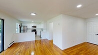 Located at 102 Blue Spring Rd in Princeton, NJ, this single-floor unit offers a clean, modern aesthetic throughout. Warm-toned hardwood floors extend across the living areas and bedrooms, creating a cohesive and inviting atmosphere. The open-concept layout connects the living room to the kitchen, making the space feel expansive and well-suited for everyday living.

The kitchen has been thoughtfully renovated with white shaker-style cabinetry extending to the ceiling, quartz countertops, a classic subway tile backsplash, and a full suite of stainless steel appliances including a refrigerator, range, over-the-range microwave, and dishwasher. A central island provides additional prep and counter space.

The generously sized living room features multiple windows and a sliding glass door that opens to a private balcony with outdoor views, allowing for abundant natural light. Baseboard heating is present throughout the unit. The bedrooms are well-proportioned, with one featuring dual closets offering ample storage. The bathroom includes a tiled tub-shower combination with a sliding glass enclosure. Recessed and flush-mount lighting throughout the unit adds to its clean, updated feel.