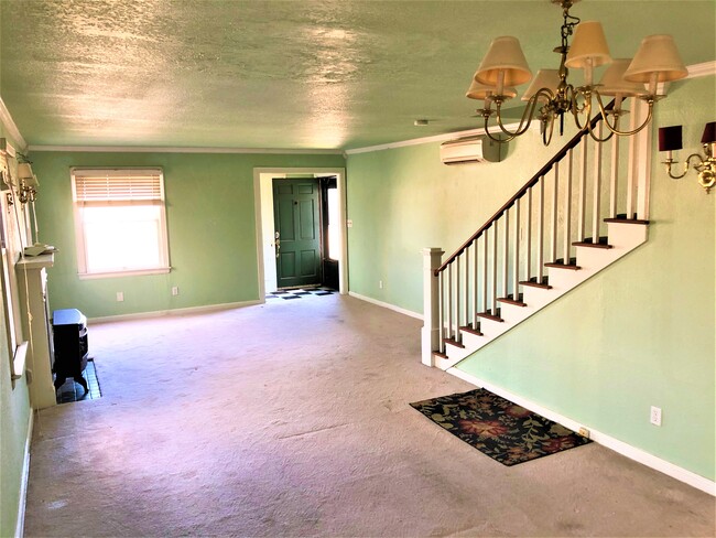Another view of living room. Stairs lead to full bath and bedrooms. - 2231 N Gatewood Ave