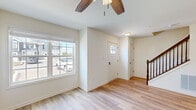 Located at 3078 Clinton Ave in Chambersburg, PA, this two-story home is designed with a clean, neutral palette and modern finishes throughout. The main level features light hardwood-style flooring that flows through the entryway, living areas, and dining space. The welcoming foyer is accented by a ceiling fan and receives natural light through a front-facing window, with a staircase providing access to the upper level.

The kitchen is a functional highlight, featuring rich dark-stained cabinetry, granite-style countertops, a stainless steel sink, and a full suite of stainless steel appliances including a range, over-the-range microwave, and refrigerator. Recessed lighting and a window enhance the workspace. Adjacent to the kitchen, the dining area is brightened by a chandelier and a sliding glass door that opens to views of the backyard greenery.

A powder room on the main level offers added convenience. Upstairs, carpeted bedrooms provide a comfortable retreat, each with windows that bring in natural light. Closets with wire shelving offer organized storage. A dedicated laundry room with a full-size washer and dryer, overhead and wall-mounted wire shelving, completes the upper level.