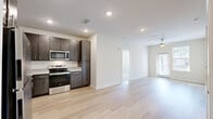 Located at 3846 Nathan Ridge Ln in Middleburg, Florida, this single-floor, 2-bedroom, 1-bathroom home offers a well-organized layout connecting living, sleeping, and utility spaces efficiently. The kitchen is a standout feature, outfitted with dark wood-toned cabinetry extending to the upper walls, granite-style countertops, and a full suite of stainless steel appliances including a refrigerator, dishwasher, electric range, and built-in microwave. Light hardwood-style flooring runs throughout the kitchen and bathroom areas, lending a clean, cohesive aesthetic. Both bedrooms are generously proportioned, carpeted for comfort, and each equipped with a ceiling fan and window fitted with blinds that allow natural light to filter in. The spacious primary bedroom connects directly to the bathroom and its own walk-in closet, while the second bedroom also benefits from an adjacent walk-in closet — both featuring wire shelving systems for practical organization. The bathroom is finished with light hardwood-style flooring, a granite-topped vanity with dark wood cabinetry, and a separate shower. A hallway connects the main areas of the home, contributing to a logical and accessible floor plan. The overall design is clean and neutral, offering a bright, move-in ready environment.