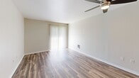 Located at 8121 236th St SW in Edmonds, Washington, this single-level one-bedroom unit offers a practical and well-appointed layout designed for efficient everyday living. Wood-look plank flooring runs throughout the main living areas, providing a clean and modern aesthetic that ties the spaces together seamlessly.

The combined kitchen and living room serves as the heart of the unit. The kitchen features warm wood cabinetry, granite-look countertops, and a full suite of black appliances including a refrigerator, electric range, and over-the-range microwave. The adjacent living area is bright and open, benefiting from a sliding glass door with vertical blinds that allows natural light to pour in and provides access to the outdoors. A ceiling fan adds comfort and functionality to the space.

The bedroom is a comfortably sized private retreat, finished with plush carpeting, neutral walls, and a window with blinds that lets in soft natural light. The overall palette throughout the unit is light and neutral, creating a clean and welcoming ambiance.

A dedicated in-unit laundry area houses a full-size top-loading washer and dryer, adding a significant convenience. Clean white walls, crisp trim, and a straightforward hallway layout round out this practical and move-in-ready home in the heart of Edmonds.