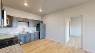 Located at 1000 Faceville Hwy in Bainbridge, Georgia, this single-floor, one-bedroom, one-bathroom unit offers a clean, modern design with thoughtfully selected finishes throughout. Light-toned hardwood-style flooring runs consistently across all rooms, creating a cohesive and bright aesthetic.

The kitchen serves as a functional centerpiece, featuring dark shaker-style cabinetry with brushed nickel hardware, granite-look countertops, a stainless steel undermount sink, and a full suite of stainless steel appliances including a refrigerator, range, and microwave. Recessed lighting illuminates the space efficiently.

The open layout adjacent to the kitchen provides a comfortable living area, offering a flexible arrangement for everyday use. The bedroom is a generously sized private retreat, equipped with a ceiling fan with light fixture, a wall-mounted mini-split HVAC unit, and a window that allows natural light and exterior views.

The bathroom is finished to match the overall style of the unit, featuring granite-topped vanity cabinetry, a tub-shower combination with grab bars, and consistent hardwood-style flooring. Clean neutral wall tones throughout the unit contribute to a bright, move-in-ready atmosphere that is both practical and inviting.