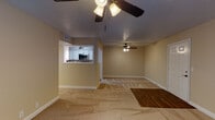 Located at 179 N Royal Oaks Blvd in Franklin, Tennessee, this single-floor residence offers a well-organized layout designed for comfortable everyday living. The open living and dining area is generously proportioned, featuring warm beige walls, a textured ceiling, and a mix of carpet and wood-look flooring. Ceiling fans are present throughout, providing both function and a casual aesthetic. A pass-through window connects the living area to the kitchen, creating an open, communicative flow between spaces.

The galley-style kitchen is well-appointed with white cabinetry, granite-look countertops, a classic subway tile backsplash, and a full suite of stainless steel appliances including a refrigerator, microwave, and electric range. Wood-look tile flooring runs throughout the kitchen, adding a durable and attractive finish.

The bedrooms are carpeted and comfortably sized, each equipped with ceiling fans and windows fitted with blinds for natural light and privacy. One bedroom features direct access to an exterior door. The bathroom presents a clean, updated look with a white vanity, stone-look countertop, framed mirror, and oil-rubbed bronze fixtures and hardware, complemented by textured walls that add subtle character. The overall ambiance of the home is neutral, bright, and move-in ready.