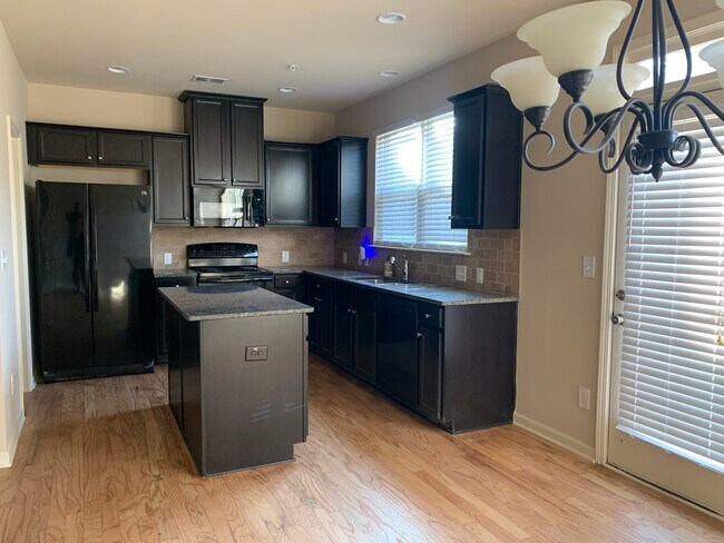 Kitchen with spacious island - 6675 Story Cir