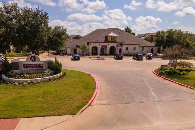 University-Trails-College-Station-Off-Campus-Apartments-Near-Texas-A&M-Main-Entrance-Monument-Sign-Clubhouse-Building-Exterior - University Trails Apartments