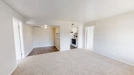 Located at 3001 E League City Pkwy in League City, TX, this single-story 2-bedroom, 2-bathroom residence offers a practical and well-organized layout designed for comfortable everyday living. The living room greets you at the entrance with plush carpeting, neutral wall tones, and a large window that fills the space with natural light and offers views of the surrounding community. The open sightlines connect the living area to the kitchen, which features white cabinetry, an electric range, and dark hardwood-style flooring that contrasts neatly with the lighter tones throughout the rest of the home. A dedicated dining room provides a defined space for meals adjacent to the kitchen. The primary bedroom is a comfortable, carpeted retreat with its own closet, while the second bedroom also offers carpeted flooring and a generous window for natural light. Each bedroom is served by its own bathroom, both featuring full tub-shower combinations with clean white tile surround. Two closets provide ample storage throughout the home, including a spacious walk-in closet with dual hanging rods. The consistent use of neutral tones and clean finishes throughout creates a bright, cohesive atmosphere across the entire residence.