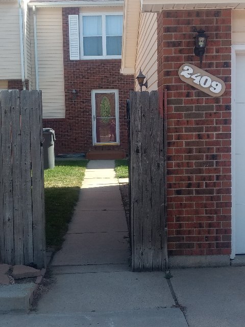 full fenced front yard (detached garage to the right) - 2409 E 16th St
