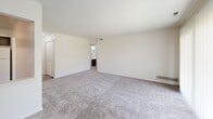 Located at 28509 Franklin Rd in Southfield, Michigan, this 1-bedroom, 1-bathroom unit offers a well-organized single-floor layout designed for comfortable everyday living. The open-concept living room is bright and inviting, featuring neutral-toned carpet, clean white walls, and a large sliding glass door that floods the space with natural light and provides views of the surrounding green landscaped grounds. A pendant light fixture anchors the living area, adding a simple, functional touch.

The kitchen is seamlessly connected to the living area via a pass-through window, creating an open and airy feel. It features rich, dark wood cabinetry with brushed nickel hardware, light countertops with a tile backsplash, hardwood-style flooring, and a full suite of appliances including a refrigerator, electric range, and dishwasher.

The spacious bedroom offers generous closet space with a wide double bi-fold closet, soft carpeting, and a clean, neutral palette. The bathroom includes a full tub-shower combination with white tile surround and chrome fixtures.

A hallway connects the rooms efficiently, and the entry opens directly into the kitchen area. Outside, mature trees and well-maintained green lawns create a pleasant, park-like setting around the building.