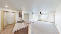 Located at 810 Seventh Ave NE in Isanti, Minnesota, this single-floor, one-bedroom, one-bathroom unit offers a practical and well-appointed layout. The open-concept kitchen and living area form the heart of the home, creating a seamless flow between cooking and relaxing spaces. The kitchen is equipped with stainless steel appliances — including a refrigerator, range, and dishwasher — complemented by rich dark-brown cabinetry, granite-look countertops, and a functional peninsula with a double sink. Light wood-style flooring runs throughout the kitchen, while a dedicated pantry provides ample storage. The living area transitions to plush carpet underfoot, with large windows that invite natural light and a ceiling fan overhead to ensure year-round comfort. The bedroom is generously sized, featuring carpeted floors, a window with exterior views, and a sliding-door closet. An additional closet offers further storage convenience. The full bathroom includes a dark-wood vanity with a wide mirror, a single-sink countertop, and a tub-shower combination. Clean, neutral finishes and recessed lighting throughout lend the space a bright, move-in-ready feel.