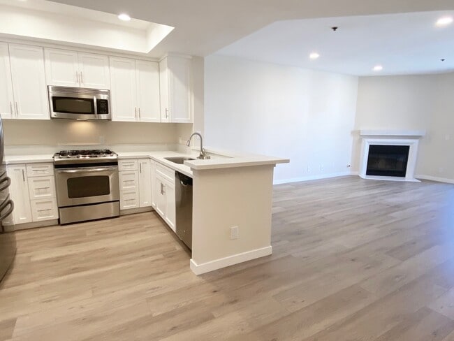 Kitchen and living area of apartment #201 - Palm Court Apartments
