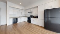 Located at 6819 N 27th Ave in Phoenix, AZ, this thoughtfully designed 2-bedroom, 2-bathroom unit offers a clean, contemporary aesthetic across a single floor. Light wood-style flooring flows consistently throughout the space, contributing to a bright and cohesive interior.

The kitchen is a functional highlight, featuring white cabinetry extending to the ceiling for ample storage, neutral countertops, a double-basin sink, and a full suite of black appliances including a gas range, dishwasher, refrigerator, and microwave. Recessed lighting adds a polished finish to this well-appointed space.

Both bedrooms are light-filled and comfortable, each equipped with ceiling fans and large windows that invite natural light and provide views of the surrounding Phoenix neighborhood. The primary bedroom offers a generous layout, while the second bedroom is equally well-proportioned.

The two bathrooms maintain the same modern palette, featuring single-sink vanities with white cabinetry, large mirrors, and wood-style flooring. Both bathrooms are equipped with stainless steel grab bars, reflecting an accessible and safety-conscious design.

Overall, the unit presents a clean, move-in-ready interior with a neutral color scheme, modern finishes, and practical features suited for comfortable everyday living in Phoenix, Arizona.