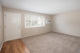 Located at 1941 W La Veta Ave in Orange, California, this single-floor, one-bedroom, one-bathroom unit offers a practical and functional layout. The living room features plush carpeting, a textured ceiling, and a wall-mounted heater unit, creating a comfortable and cozy atmosphere. Natural light filters in through a large front window, and a wall-mounted air conditioning unit provides climate control. The combined dining and kitchen area is a standout feature, boasting warm wood-tone cabinetry, dark granite-style countertops, stainless steel gas range, and wood-look flooring that extends throughout the dining space. A window above the sink brings in additional natural light. A louvered pantry door adds convenient kitchen storage. The bedroom is generously sized with soft carpeting, a ceiling fan with light fixture, a window overlooking the outdoors, and a sliding mirrored closet. The unit includes a total of three closets, providing excellent storage throughout. The full bathroom features a tub/shower combo with chrome fixtures and wood-look flooring. A hallway connects the main living areas, completing this well-organized and efficiently designed single-level home.