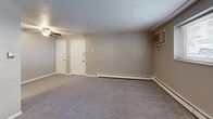 Located at 600 Stevens Dr in Pittsburgh, PA, this three-bedroom, one-bathroom unit offers a practical and efficient single-floor layout. The spacious primary bedroom is notably generous in size, featuring a wall-mounted air conditioning unit, baseboard heating, and a window that brings in natural light with views of the surrounding area. Two additional bedrooms each include ceiling fans with light fixtures, carpeted flooring, baseboard heating, and windows with blinds, providing comfortable and functional living spaces. Two closets offer ample storage throughout the unit. The kitchen is equipped with warm wood-toned cabinetry, a white electric range, and a sink with countertop workspace, all set on hard surface flooring. The full bathroom features a shower-tub combination with clean white surrounds and yellow accent tile detailing. The main living area is open and carpeted, with textured ceilings throughout the unit, dual closet access, a ceiling fan, and baseboard heating supplemented by a wall A/C unit. Natural light filters through multiple windows across the unit, contributing to a bright and livable atmosphere throughout.
