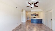 Located at 103 Abbey Ln #9 in Savoy, IL, this well-appointed one-bedroom, one-bathroom unit offers a thoughtfully designed single-floor layout. The open-concept living and kitchen area is bright and welcoming, featuring light hardwood-style flooring, vaulted ceilings, and a ceiling fan. Large windows allow natural light to fill the space, enhancing the airy feel throughout.

The kitchen is a standout feature, equipped with rich dark cabinetry, stainless steel appliances including a range, microwave, and refrigerator, and a peninsula island with a white countertop and built-in sink — ideal for both cooking and casual dining. A walk-in pantry closet adds convenient storage.

The bedroom is generously sized, finished with plush carpet and neutral walls, and connects directly to the full bathroom. The bathroom features tile flooring, a dark-wood vanity with a white countertop, and direct access to a walk-in closet with built-in shelving.

A dedicated laundry area houses a full-size washer and dryer, adding everyday convenience. The attached garage features a concrete floor, automatic opener, and a window for natural light — providing secure parking and additional storage space. Two closets throughout the unit further enhance storage capacity.
