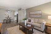 This 860 square foot apartment in Grand Prairie, TX offers a well-designed living space with two bedrooms and two bathrooms. The interior showcases a modern aesthetic with neutral color palette and contemporary finishes. The open-concept layout maximizes the use of space, creating a seamless flow between the living area and kitchen.

The flooring throughout is a durable, wood-look material that adds warmth and character to each room. The primary bedroom, measuring 100 square feet, provides a cozy retreat with ample natural light from the window. Both bedrooms feature ceiling fans for added comfort.

The kitchen is equipped with updated appliances, including a black refrigerator, and boasts granite countertops and a tiled backsplash. The bathrooms are tastefully appointed with tiled surrounds in the shower/tub area, featuring an accent strip for visual interest.

The living area is brightened by large windows and a sliding glass door, allowing natural light to flood the space. Built-in closets in both bedrooms offer practical storage solutions. The overall design emphasizes functionality and modern living, making efficient use of the compact 860 square foot floor plan.
