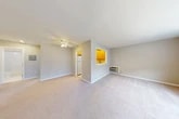 Located at 44 Center Grove Rd in Randolph, NJ, this one-bedroom, one-bathroom residence offers a well-organized single-floor layout with a comfortable and functional living environment. The open living and dining area is generously sized, featuring neutral-toned carpet, a ceiling fan with light fixture, and a large window that invites natural light and views of the surrounding neighborhood. A wall-unit HVAC system provides efficient climate control. The kitchen is accessible via a pass-through opening and a direct entryway, showcasing warm honey-toned wood cabinetry, white countertops, a stainless steel sink with a modern pull-down faucet, a tile backsplash, and a dishwasher — all set over tile flooring. The bedroom offers a comfortable footprint with plush carpeting, a wide window overlooking the community, a dedicated closet with a bi-fold door and hanging rod, and a wall-unit HVAC system beneath the window. Three closets throughout the unit provide ample storage. The space is finished with clean white trim, neutral walls, and consistent flooring choices that give the home a cohesive, move-in-ready aesthetic throughout.
