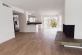 This contemporary 1070 square foot apartment in Thanisandra, Mesthri Palya, offers a harmonious blend of style and functionality. The open-plan layout seamlessly integrates the living room and kitchen, creating a spacious atmosphere ideal for both relaxation and entertainment. Floor-to-ceiling windows flood the space with natural light, providing stunning views of the surrounding greenery.

The kitchen is a chef's delight, featuring modern stainless steel appliances, ample white cabinetry, and sleek dark countertops. Both bedrooms are generously sized, with the primary bedroom boasting 210 square feet of space. The bathrooms showcase modern design with large format tiles, glass shower enclosures, and updated fixtures.

Throughout the apartment, light-toned wood flooring adds warmth and elegance. The living area is further enhanced by a unique floating fireplace, adding both visual interest and coziness. Ceiling fans and recessed lighting contribute to the overall comfort and ambiance.

This single-story residence strikes a perfect balance between contemporary design and practical living, making it an ideal home for those seeking a modern urban lifestyle.
