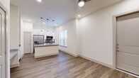 Located in Cross Roads, TX, this well-designed single-story, one-bedroom, one-bathroom home makes excellent use of its compact footprint. The open-concept layout seamlessly connects the living room, dining area, and kitchen into one cohesive space. Soaring ceilings and a ceiling fan enhance the sense of volume throughout the main living area, while wood-style plank flooring adds warmth and continuity.

The kitchen is a functional highlight, featuring stainless steel appliances including a refrigerator and microwave, a kitchen island with granite countertops, white cabinetry, a stylish subway tile backsplash, and pendant lighting that adds a modern touch. A window over the sink brings in natural light.

The bedroom is carpeted for comfort, offering a large window with exterior views and ample natural light. Three closets provide generous storage, including a dedicated walk-in closet with built-in shelving and hanging rods. A hallway connects the bedroom to the bathroom, which features a white vanity with granite countertops, a large mirror, wood-style flooring, and a walk-in marble-tiled shower. Additional rooms include a laundry area and a pantry for added convenience.

Outside, a private yard enclosed by a wooden fence offers a peaceful outdoor retreat, completing this smartly designed home.