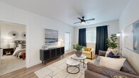 Located at 1021 Solace Pond View in Colorado Springs, CO, this single-floor, 2-bedroom, 2-bathroom residence offers a clean, modern aesthetic with a practical and comfortable layout. The open-concept living room features wood-look flooring, a ceiling fan with light fixture, and multiple windows dressed with blinds and navy accent curtains that allow for ample natural light. The kitchen is a standout, boasting white shaker cabinetry, a classic subway tile backsplash, stainless steel appliances, and a large white quartz peninsula with bar seating for three, illuminated by stylish pendant lighting. A well-lit hallway connects the main living areas to the bedrooms, with recessed lighting and wall hooks for added functionality. The spacious primary bedroom features plush carpet, a ceiling fan, and a bright window with sheer curtains, creating a comfortable retreat. The second bedroom is equally well-sized with carpet flooring and its own ceiling fan. Both bathrooms are finished with white cabinetry, undermount sinks, matte black fixtures, and wood-look flooring, with one bathroom featuring a full tub-shower combination. A dedicated closet and hallway round out this well-designed residence.