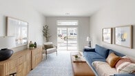 Located at 25 Jerome Ave in Bloomfield, Connecticut, this single-floor residence showcases a clean, modern design with a cohesive neutral palette throughout. Light wood-look flooring runs through the main living areas, complementing the bright white walls and creating an airy, welcoming atmosphere.

The open-concept kitchen is a standout feature, equipped with dark espresso cabinetry, stainless steel appliances including a refrigerator, range, and microwave, and crisp white quartz countertops. A curved peninsula with seating for three provides both additional prep space and a casual dining area, while pendant lighting adds a contemporary finishing touch.

The living area is generously proportioned, benefiting from large sliding glass doors that flood the space with natural light and provide direct outdoor views. The seamless flow between the kitchen and living room makes the layout highly functional.

The bedroom offers a comfortable, well-lit retreat with a large window, double closet, and neutral tones that contribute to a calm ambiance. The bathroom features a dark wood vanity with a white countertop, a large frameless mirror, modern fixtures, and a tub-shower combination with tiled surround — delivering a practical yet polished finish throughout.