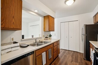 Well-appointed kitchens offer wood cabinetry and stainless steel dishwashers for modern convenience, professionally operated by Highlands Vista Group. - Madison Estates