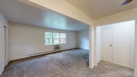 Located at 1 Hillside Ave in Rockaway, NJ, this one-bedroom, one-bathroom unit offers a thoughtfully organized single-floor layout with a comfortable and functional living environment. The living room is generously sized, featuring wall-to-wall carpeting, baseboard heating, a wall-mounted AC unit, and wide windows that frame lush, leafy outdoor views, filling the room with natural light. The spacious bedroom continues the carpeted flooring and neutral palette, with a window overlooking greenery and baseboard heating, creating a calm and quiet retreat. The kitchen is well-appointed with dark wood cabinetry, stone-look countertops, a classic tile backsplash, and white appliances including a refrigerator, dishwasher, and range. A window above the sink brings in natural light, while wood-look vinyl flooring and a baseboard heater complete the space. The bathroom features full tub-shower combination with large-format beige tile surround, tile flooring, and a privacy window. A hallway connects the rooms seamlessly, and a closet near the entry provides convenient storage. Neutral tones and clean finishes throughout give this unit a bright, move-in ready feel.
