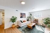 Located at 3106 Memorial Dr SE in Atlanta, GA, this one-bedroom, one-bathroom unit offers a thoughtfully designed layout across a single floor. Light wood flooring flows throughout, tying together a clean, modern aesthetic brightened by natural light from multiple windows fitted with white blinds.

The living room is an inviting, open space featuring white walls, flush-mount lighting, and windows that allow sunlight to fill the room generously. The kitchen is well-equipped with white shaker-style cabinetry, granite countertops, stainless steel appliances including a range, dishwasher, microwave, and refrigerator, plus a stainless undermount sink — a functional and stylish workspace.

The bedroom is a comfortable, well-proportioned retreat with a ceiling fan, natural light from a window, and clean white walls that create a serene atmosphere. A dedicated closet provides additional storage. The hallway also features space for a stacked in-unit washer and dryer, adding a layer of everyday convenience.

The bathroom is finished with white subway tile surrounding the tub/shower combo, a granite-top vanity with white cabinetry, black hardware accents, and an LED-backlit mirror, striking a clean and contemporary tone throughout.