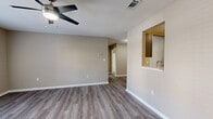Located at 342 Riverwood Dr in Crestview, Florida, this single-floor, one-bedroom, one-bathroom home offers a well-designed layout with a comfortable and functional living experience. The open-concept living and kitchen area serves as the heart of the home, featuring durable vinyl plank flooring, neutral warm-toned walls, and a ceiling fan with light fixture. French doors flood the living space with natural light and provide direct access to the private patio, offering a seamless indoor-outdoor connection. The kitchen is appointed with grey shaker-style cabinetry, white quartz countertops, a subway tile backsplash, a stainless steel sink, and a full suite of stainless steel appliances including a range, microwave, refrigerator, and dishwasher. The bedroom is carpeted for comfort, features a ceiling fan, a window with outdoor views, and benefits from three closets throughout the unit for ample storage. The bathroom is well-appointed with a grey shaker-style vanity, white countertop, a lighted mirror, and a full tub-shower combination. A dedicated laundry area with wire shelving and washer/dryer hookups rounds out the practical layout of this efficiently designed home.