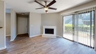 Located at 1850 Ashley Crossing Lane in Charleston, SC, this single-floor unit offers a well-organized layout with a clean, modern aesthetic throughout. The living area serves as the heart of the home, featuring wood-look flooring, neutral gray walls, a textured ceiling, and a ceiling fan with light fixture. A tiled wood-burning fireplace anchors the main living space, while a sliding glass door opens to a private patio overlooking lush greenery, filling the room with natural light.

The galley-style kitchen is efficiently designed with white cabinetry, dark granite-style countertops, stainless steel appliances including a refrigerator, electric range, dishwasher, and ample overhead and base cabinet storage.

The bedrooms continue the wood-look flooring and neutral color palette, each benefiting from natural light provided by blinded windows with views of the surrounding landscape. The layout connects the rooms with good flow and functional hallway access.

The bathroom features a full tub and shower combination with classic white subway tile surround, chrome fixtures, a vanity with dark countertop, and wood-look flooring, providing a clean and practical space. The overall ambiance is bright, tidy, and move-in ready.
