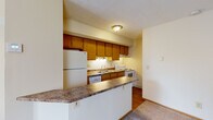 Located at 278 Silver Maple Dr in Delaware, Ohio, this two-floor residence offers a practical and comfortable layout across its levels, connected by an interior staircase. The main floor centers around an open living and dining area finished with plush carpeting, which flows seamlessly into a well-equipped kitchen. The kitchen features warm oak cabinetry with ample upper and lower storage, laminate countertops, a double-basin sink, and white appliances including a refrigerator, electric range, dishwasher, and microwave. A peninsula with a granite-style countertop provides additional prep space and serves as a natural divider between the kitchen and living area. The textured ceilings are consistent throughout the home, adding a classic touch. The upper level hosts the bedrooms, each carpeted and filled with natural light from multiple windows fitted with blinds. At least one bedroom includes a walk-in closet with built-in shelving. The bathroom is well-appointed with a wood-framed vanity, granite-style countertop, a combined tub and shower, and warm hardwood-style flooring. The overall ambiance is clean, neutral, and move-in ready, offering a welcoming environment throughout.