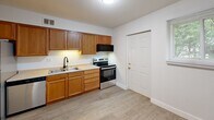 Located at 1308 W Covington Ct in Peoria, IL, this single-floor unit offers three bedrooms and two bathrooms within a thoughtfully arranged floor plan. Light-toned luxury vinyl plank flooring runs throughout the entire space, lending a clean, cohesive look to every room.

The kitchen is well-equipped with warm oak cabinetry, a stainless steel electric range, stainless steel refrigerator, dishwasher, and a double-basin sink, providing ample storage and functionality. The kitchen opens toward the living area, creating a connected flow between spaces.

The generously sized primary bedroom offers notable square footage and features a ceiling fan with light fixture. The two additional bedrooms are similarly finished with ceiling fans, LVP flooring, and windows that invite natural light — one bedroom includes a sliding-door closet. Each bedroom provides comfortable, versatile living space.

The two bathrooms are cleanly finished; one features classic square tile wainscoting with a vanity and mirrored medicine cabinet, while the other includes a full tub-and-shower surround with matte black fixtures. A central hallway connects the bedrooms and bathrooms efficiently.

Overall, the unit presents a bright, neutral aesthetic with consistent finishes throughout, making it a practical and move-in ready home.