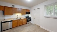 Located at 1308 W Covington Ct in Peoria, IL, this single-floor unit offers three bedrooms and two bathrooms within a thoughtfully arranged floor plan. Light-toned luxury vinyl plank flooring runs throughout the entire space, lending a clean, cohesive look to every room.

The kitchen is well-equipped with warm oak cabinetry, a stainless steel electric range, stainless steel refrigerator, dishwasher, and a double-basin sink, providing ample storage and functionality. The kitchen opens toward the living area, creating a connected flow between spaces.

The generously sized primary bedroom offers notable square footage and features a ceiling fan with light fixture. The two additional bedrooms are similarly finished with ceiling fans, LVP flooring, and windows that invite natural light — one bedroom includes a sliding-door closet. Each bedroom provides comfortable, versatile living space.

The two bathrooms are cleanly finished; one features classic square tile wainscoting with a vanity and mirrored medicine cabinet, while the other includes a full tub-and-shower surround with matte black fixtures. A central hallway connects the bedrooms and bathrooms efficiently.

Overall, the unit presents a bright, neutral aesthetic with consistent finishes throughout, making it a practical and move-in ready home.