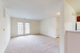 Located at 1050 Claire Taylor Ct in Culpeper, Virginia, this single-floor, 2-bedroom, 2-bathroom home offers a well-organized and functional layout. The living room is a standout space, featuring plush wall-to-wall carpeting, neutral cream-toned walls, and a pair of French doors that invite natural light and provide access to an outdoor area. The open sightlines between the living and dining areas create a comfortable, connected flow throughout the main living space. The kitchen is equipped with warm cherry wood cabinetry, light speckled countertops, white appliances including a range and dishwasher, a double stainless steel sink, and easy-care tile flooring. A half-wall peninsula visually connects the kitchen to the adjacent living and dining areas. Both bedrooms are carpeted and bright, with the primary bedroom offering a generous footprint. The second bedroom features a large window with outdoor views. Two full bathrooms include vanities with cherry wood cabinetry and tub-shower combinations. The home also includes a dedicated laundry area, a utility room, two hallways, an entrance, a dining room, and an impressive five closets, providing exceptional storage throughout.