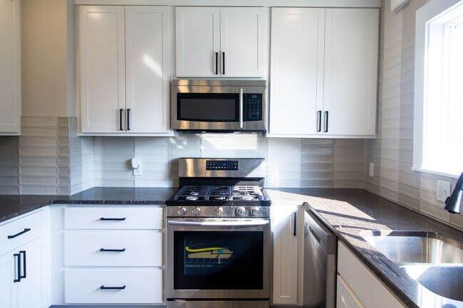 Large cabinets to the ceiling with new stainless steel appliances - 218 Commonwealth Ave