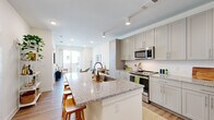 Located at 620 W Due West Ave in Nashville, TN, this thoughtfully designed one-bedroom, one-bathroom residence offers a cohesive open-concept layout with modern finishes throughout. Light-toned hardwood floors and recessed lighting create a clean, contemporary ambiance across the single floor.

The kitchen is a standout feature, showcasing shaker-style cabinetry in a soft grey hue, granite countertops, and a full suite of stainless steel appliances including a refrigerator, range, and built-in microwave. A generous kitchen island with seating provides both additional prep space and a natural gathering area that flows seamlessly into the living room.

The living room is bright and inviting, anchored by a large sliding glass door that draws in natural light and offers views of the surrounding exterior. This connection to the outdoors enhances the sense of openness throughout the space.

The bedroom is a comfortable, well-proportioned retreat featuring multiple windows with natural light and a ceiling fan. A dedicated closet provides practical storage.

The bathroom continues the design language of the home with grey shaker cabinetry, granite countertops, a large mirror, and hardwood-style flooring, giving it a polished and cohesive look. The overall aesthetic is modern, neutral, and move-in ready.
