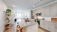 Located at 620 W Due West Ave in Nashville, TN, this thoughtfully designed one-bedroom, one-bathroom residence offers a cohesive open-concept layout with modern finishes throughout. Light-toned hardwood floors and recessed lighting create a clean, contemporary ambiance across the single floor.

The kitchen is a standout feature, showcasing shaker-style cabinetry in a soft grey hue, granite countertops, and a full suite of stainless steel appliances including a refrigerator, range, and built-in microwave. A generous kitchen island with seating provides both additional prep space and a natural gathering area that flows seamlessly into the living room.

The living room is bright and inviting, anchored by a large sliding glass door that draws in natural light and offers views of the surrounding exterior. This connection to the outdoors enhances the sense of openness throughout the space.

The bedroom is a comfortable, well-proportioned retreat featuring multiple windows with natural light and a ceiling fan. A dedicated closet provides practical storage.

The bathroom continues the design language of the home with grey shaker cabinetry, granite countertops, a large mirror, and hardwood-style flooring, giving it a polished and cohesive look. The overall aesthetic is modern, neutral, and move-in ready.