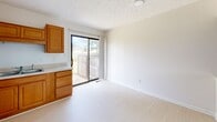 Located at 605 S Reilly Rd in Fayetteville, NC, this single-story, one-bedroom, one-bathroom unit offers a well-organized layout designed for comfortable everyday living. Light-toned flooring runs throughout the space, creating a clean and cohesive aesthetic.

The kitchen is a functional highlight, featuring warm honey-toned wood cabinetry that extends to the upper walls, providing ample storage. White appliances, including a full-size refrigerator and range with overhead ventilation, complement the neutral countertops and double-basin sink. A sliding glass door adjacent to the kitchen opens to a fenced outdoor patio, bringing in natural light and offering a private outdoor retreat.

The bedroom is a well-proportioned, quiet room with a textured ceiling, a window that allows in natural light, light flooring, and a closet. The clean white walls and neutral tones contribute to a calm and restful atmosphere.

The bathroom is straightforward and practical, featuring a full-size tub and shower surround with clean white finishes. Overall, this unit provides a compact yet functional living environment with practical amenities suited for individuals or couples seeking a manageable, low-maintenance space in Fayetteville.