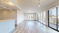 Located at 3737 S Bentley Ave in Los Angeles, this modern 2-bedroom, 2-bathroom residence offers a thoughtfully designed open-concept layout across a single floor. The spacious living area is bathed in natural light, featuring light-toned hardwood-style flooring, recessed lighting, and large glass doors that open to a private balcony with open city views. The kitchen is well-appointed with dark espresso cabinetry, white quartz countertops, a mosaic tile backsplash, and a full suite of stainless steel appliances including a gas range, microwave, dishwasher, and refrigerator. A peninsula with an undermount sink adds both functionality and style. Both bathrooms are finished with neutral porcelain tile flooring, sliding glass shower enclosures over soaking tubs, and modern vanities with ample mirror space. The two bedrooms feature plush carpeting and dedicated closets, with the primary bedroom offering generous proportions and a bright window framing outdoor greenery. Each bedroom is served by its own closet for added storage convenience. Clean white walls, recessed lighting throughout, and a cohesive modern palette give the entire space a bright, contemporary ambiance ideal for urban living in West Los Angeles.