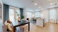 Located at 8402 IBM Drive in Charlotte, NC, this single-floor residence offers a thoughtfully designed open-concept layout with two bedrooms and two full bathrooms. Light-toned hardwood-style flooring flows through the main living areas, enhancing the bright, airy atmosphere created by multiple windows dressed with blinds and stylish curtains throughout.

The kitchen is a standout feature, boasting white cabinetry, granite countertops, stainless steel appliances including a refrigerator, range, microwave, and dishwasher, and a peninsula with bar seating. It opens seamlessly into the living room, which is anchored by a ceiling fan and generous natural light. The adjacent dining area provides dedicated space for meals and features direct access to an outdoor area via glass doors.

The primary bedroom is a comfortable retreat with plush carpeting, large windows, and a ceiling fan. The second bedroom mirrors this warmth, featuring a distinctive green accent wall and ample natural light. Both bathrooms are finished with granite-topped white vanities and hardwood-style flooring; one includes a glass-enclosed walk-in shower, while the other features a shower-tub combination. A hallway connects the private areas of the residence, completing this efficient and modern floor plan.