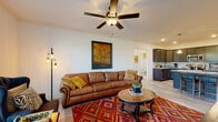 This single-floor residence at 2601 Sandersville Rd in Lexington, Kentucky offers a well-designed layout that balances comfort and functionality. The open-concept living area serves as the heart of the home, featuring light wood-style flooring, crown molding, and a ceiling fan overhead. Large windows dressed with blinds allow natural light to fill the space, creating a warm and inviting ambiance.

The kitchen is outfitted with dark espresso cabinetry, granite countertops, a white subway tile backsplash, and a full suite of stainless steel appliances, including a range, microwave, and refrigerator. The space flows seamlessly from the kitchen into the living area, making it ideal for everyday living.

Two well-appointed bedrooms each feature light wood-style flooring, natural light from sizable windows, and easy access to storage. One bedroom includes a walk-in closet with wire shelving, providing ample organization space.

The two bathrooms are finished with marble-style tile flooring, dark vanity cabinetry, and granite countertops. One bathroom features a tub/shower combination, while the other offers a standalone glass-enclosed shower. A dedicated in-unit laundry room houses a full-size washer and dryer with overhead wire shelving for added convenience.
