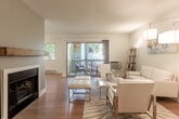 Located at 100 Buckingham Dr in Santa Clara, CA, this well-designed 3-bedroom, 2-bathroom single-floor residence offers a comfortable and functional layout. Light wood flooring flows throughout the home, complementing the neutral color palette that creates a bright, welcoming atmosphere.

The living room serves as the heart of the home, featuring a classic fireplace with a rustic wood mantel and sliding glass doors that open onto a private balcony — ideal for enjoying outdoor views and fresh air. The adjacent kitchen is galley-style with white shaker cabinetry, granite-look countertops, and a full suite of stainless steel appliances including a range, microwave, dishwasher, and refrigerator.

The primary bedroom is generously sized, offering natural light through large windows. All three bedrooms feature light wood flooring and ample closet space — with six closets total across the home. The two bathrooms are finished with granite countertops, white vanity cabinetry, and clean tile work, including a shower-tub combo with sleek glass sliding doors.

A dedicated laundry area with a stacked washer and dryer adds everyday convenience. Hallways connect the rooms efficiently, enhancing the home's practical flow. Textured ceilings are found throughout the residence.