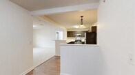 Located at 5000 Stein Dr in Cranberry Township, PA, this well-appointed single-floor home offers three bedrooms, two bathrooms, and a thoughtfully designed layout. The open-concept kitchen and living area serves as the heart of the home, where a U-shaped kitchen is outfitted with dark shaker-style cabinetry, stainless steel appliances including a refrigerator, range, microwave, and dishwasher, and light countertops. A peninsula with a breakfast bar connects seamlessly to the living room, which features wood-look flooring and flows into carpeted spaces beyond. The primary bedroom is generously sized, boasting vaulted ceilings, a large multi-pane window, and a door to an outdoor area, filling the room with natural light. It is complemented by a walk-in closet with built-in wire shelving and a private en-suite bathroom featuring a wide vanity with dark cabinetry, a well-lit mirror, and a tub/shower combination. The two additional bedrooms offer comfortable dimensions, carpeted floors, and windows with natural light. The second bathroom mirrors the same clean, consistent design. Two hallways and two closets provide ample circulation and storage throughout this practical and attractive home.