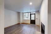 Located at 314 N Franklin St in the heart of downtown Madison, Wisconsin, this multi-level 2-bedroom, 1-bathroom residence spans three floors, offering a well-organized and functional layout throughout. The entry level, the most spacious of the three floors, welcomes you with durable wood-look flooring, recessed lighting, and a striking dark-framed glass entry door that frames views of the surrounding brick exterior. A fireplace and a double-door closet make this level a comfortable and inviting living area. The kitchen is well-appointed with light maple cabinetry, dark countertops, a mosaic tile backsplash, and a full suite of stainless steel appliances including a refrigerator, dishwasher, range, and microwave. An adjacent dining area completes this level's functional core. The upper floors are home to two bedrooms, including a generously sized primary bedroom featuring plush carpeting, wide windows with blinds, and ample natural light. The bathroom is clean and modern, with large-format tile in the walk-in shower, chrome fixtures, and wood-look tile flooring. Three closets provide abundant storage throughout, and three staircases connect the floors efficiently. The space presents a contemporary aesthetic with neutral tones, warm wood accents, and thoughtful details throughout.