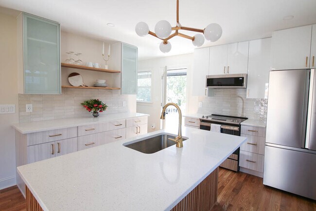 A kitchen for entertaining guests with a good sized deck out the back door. - 2406 Boswell Rd