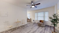 Located at 6406 Franklin Ave in the heart of Los Angeles, CA, this single-floor studio offers a well-organized and efficiently designed layout comprising a living area, kitchen, bathroom, and closet. The living space is bright and airy, featuring light gray wood-style flooring that runs throughout, crisp white walls, and a ceiling fan with an integrated light fixture that adds both function and style. Multiple windows dressed with white blinds allow ample natural light to fill the room, creating an inviting and open ambiance. A dedicated nook within the living area provides space for a desk or dining setup, adding versatility to the layout. The kitchen is thoughtfully equipped with warm-toned wood cabinetry, granite-style countertops, a stainless steel sink, a gas range, and a full-size refrigerator, making the most of the available space. The bathroom is clean and modern, featuring a white vanity with a round mirror, a shower/tub combination, and light tile flooring that complements the rest of the unit. A dedicated closet provides practical storage. The consistent flooring, neutral color palette, and natural light throughout give this studio a cohesive and comfortable feel, well-suited for city living in the vibrant Hollywood neighborhood.