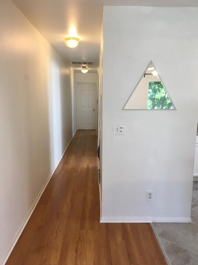 Long hallway with brand new wood floor - 117 W Sycamore Ave