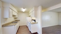 Located at 647 West Barstow Avenue in Clovis, CA, this single-story, one-bedroom, one-bathroom unit offers a functional and well-appointed layout across a compact yet efficient floor plan. The living room serves as the welcoming heart of the space, featuring rich wood-style laminate flooring, a textured ceiling, and a large window fitted with vertical blinds that allows generous natural light to fill the room. A ceiling fan with light fixture adds comfort to the adjoining dining area, which flows seamlessly toward the kitchen. The galley-style kitchen is thoughtfully designed with white cabinetry lining both walls, providing ample upper and lower storage. It is equipped with a white electric range, refrigerator, and a single-basin sink, all set atop laminate countertops that complement the wood-style flooring. The bedroom is a comfortable retreat finished with plush carpeting, a ceiling fan, a window with outdoor views, and a sliding-door closet. The full bathroom features a tub-shower combination with tiled surround, a vanity with granite-style countertop, a large mirror, and a small window for ventilation. Wood-style flooring continues into the bathroom, tying the unit's aesthetic together cohesively.