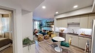 Located at 505 W Crowther Ave in Placentia, CA, this thoughtfully designed one-bedroom, one-bathroom residence offers a smart, open-concept layout that maximizes every square foot. Light wood-tone flooring flows seamlessly throughout, lending warmth and visual continuity to the space.

The kitchen is outfitted with sage-toned flat-front cabinetry, under-cabinet lighting, a tile backsplash, dark countertops, and a full suite of stainless steel appliances including a gas range, built-in microwave, dishwasher, and refrigerator. A compact dining area sits adjacent, creating an efficient and connected cooking and dining zone.

The living room is bright and welcoming, with large windows that invite natural light and provide access to an outdoor area. Recessed lighting and open wall shelving add both function and character to the space.

The bedroom offers a calm, cozy retreat with soft neutral tones, a window with natural light, and a dedicated closet. The bathroom features a full tub and shower combination, a vanity with storage, and a bold green accent wall that adds a striking design detail.

A hallway connects the main living areas, contributing to a coherent and practical flow. Overall, the residence presents a modern aesthetic balanced with warm, livable touches throughout.